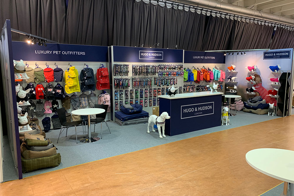 Hugo and Hudson Exhibition stand at PATS 2020, featuring tension fabric graphics, large slatwall display areas and magnetic shelf display areas